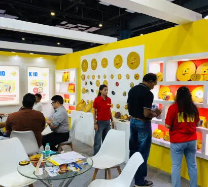 Interior of K-10 exhibition stall showcasing abrasive products on illuminated shelves