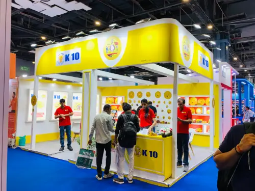 K-10 exhibition stall with yellow and white branding, illuminated displays and overhead fascia | | **Image 2 – Interior View** | `k10-abrasive-products-display-interior.webp` | Interior of K-10 exhibition stall showcasing abrasive products on illuminated shelves | | **Image 3 – Product Display View** | `k10-exhibition-product-display-and-seating.webp` | K-10 abrasive product displays with visitor seating and illuminated wall-mounted shelves |